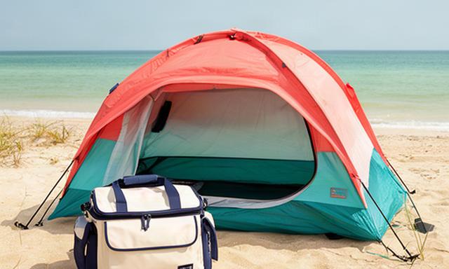 Pop-up beach shelter and insulated cooler bag set on Florida sand