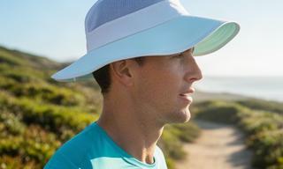 SunFlex UPF 50 running hat worn on a bright coastal trail